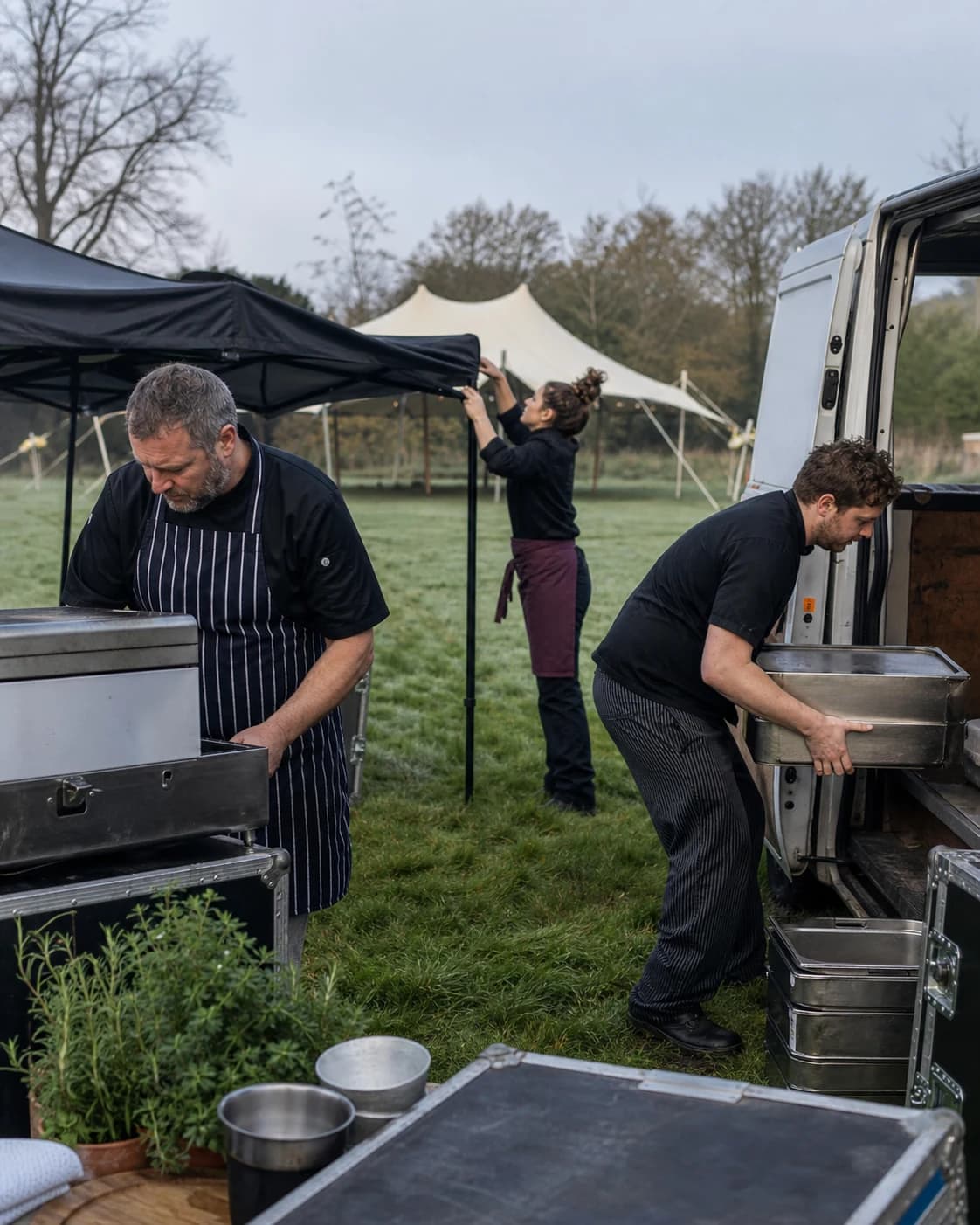 Adam Skinner and the Pig & Pickle Catering team setting up an outdoor kitchen before service